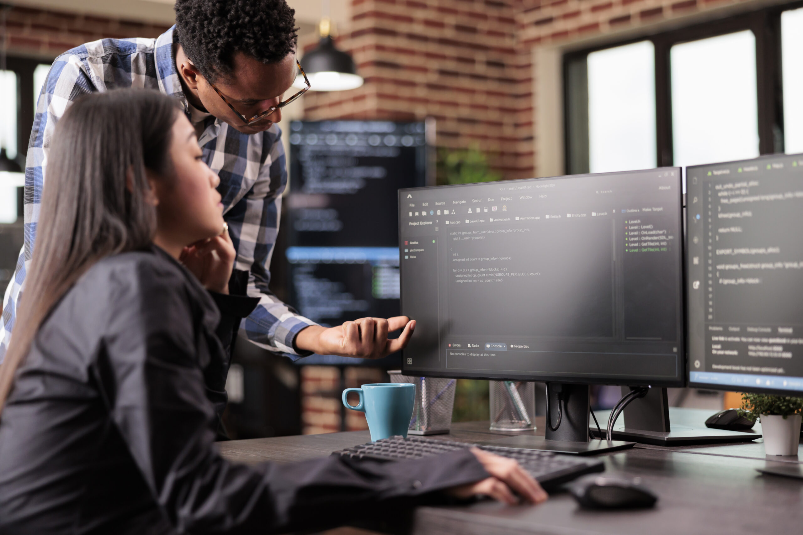 Diverse Programmers Discussing About Html Code Compiling Discovers Errors Standing Front Multiple Screens Startup Office Software Developers Working Server Interface Development 1 Scaled